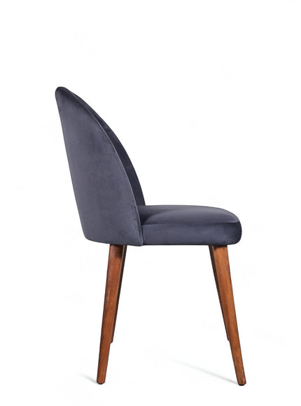 Front angled view of the Vaya Home Limett dining chair with yellow upholstery, cushioned seat, and tapered wood legs.