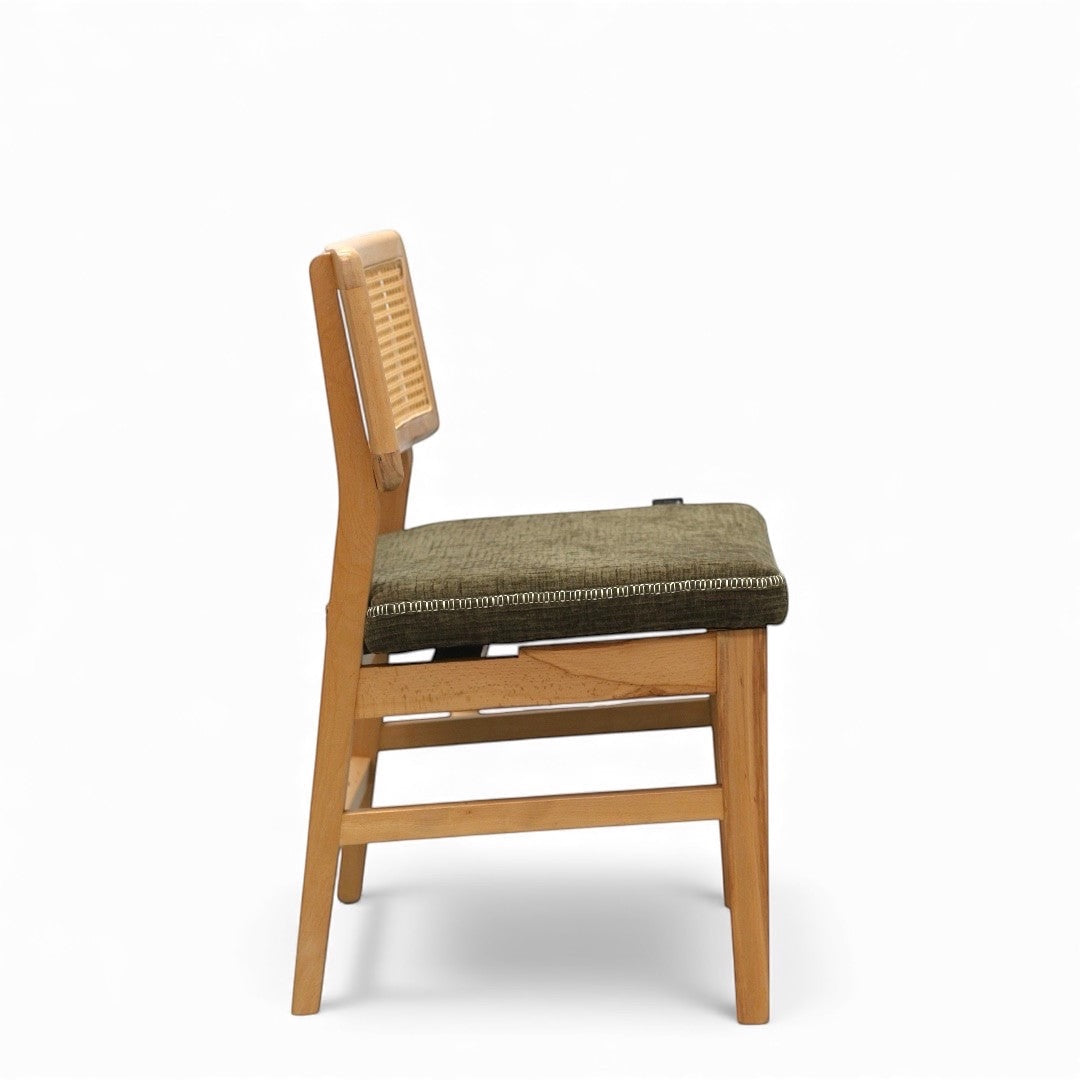 Side view of the Vaya Home Lino dining chair showing the cane backrest, upholstered seat cushion, and wood frame.