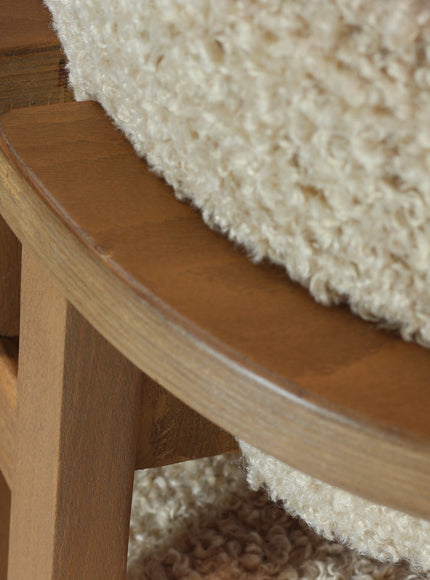 Close-up of the Vaya Home Loft dining chair showing beige boucle upholstery and wood frame detail.