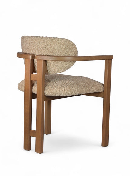 Front angled view of the Vaya Home Loft dining chair featuring beige boucle upholstery and a warm wood frame.