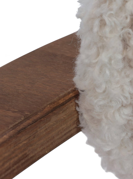 Close-up of the Vaya Home Loft dining chair showing white boucle upholstery and wood frame detail.