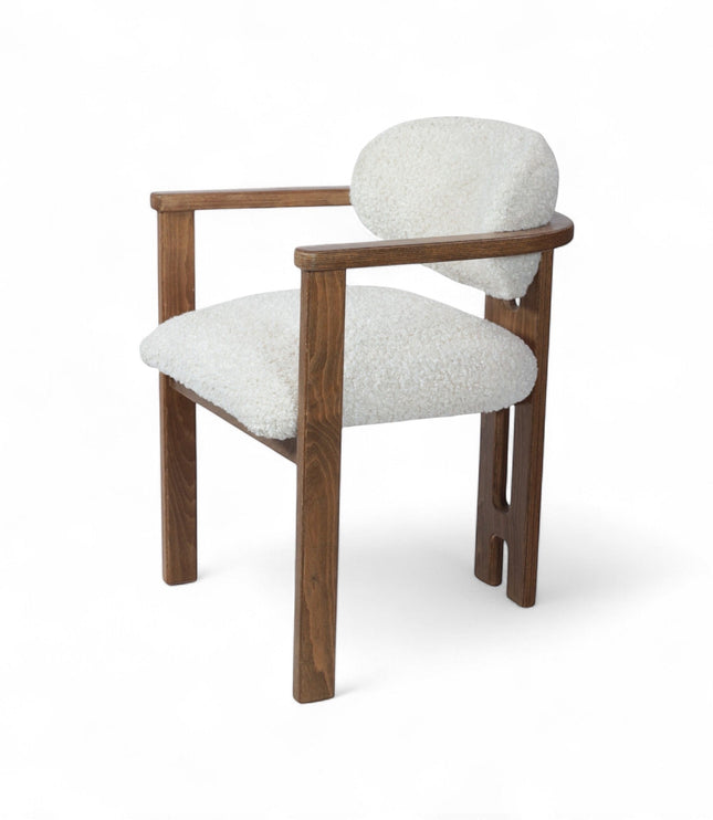 Rear angled view of the Vaya Home Loft dining chair with white boucle upholstery, rounded back cushion, and a warm wood frame.