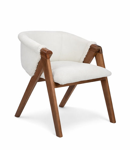 Front angled view of the Vaya Home Masiccio dining chair with white boucle upholstery, curved back, and wood frame.