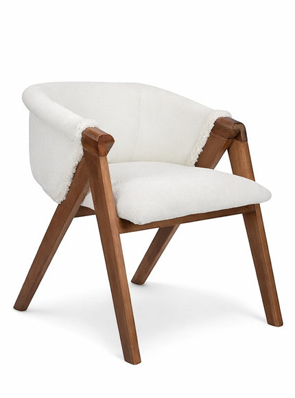 Front angled view of the Vaya Home Masiccio dining chair with white boucle upholstery, curved back, and wood frame.