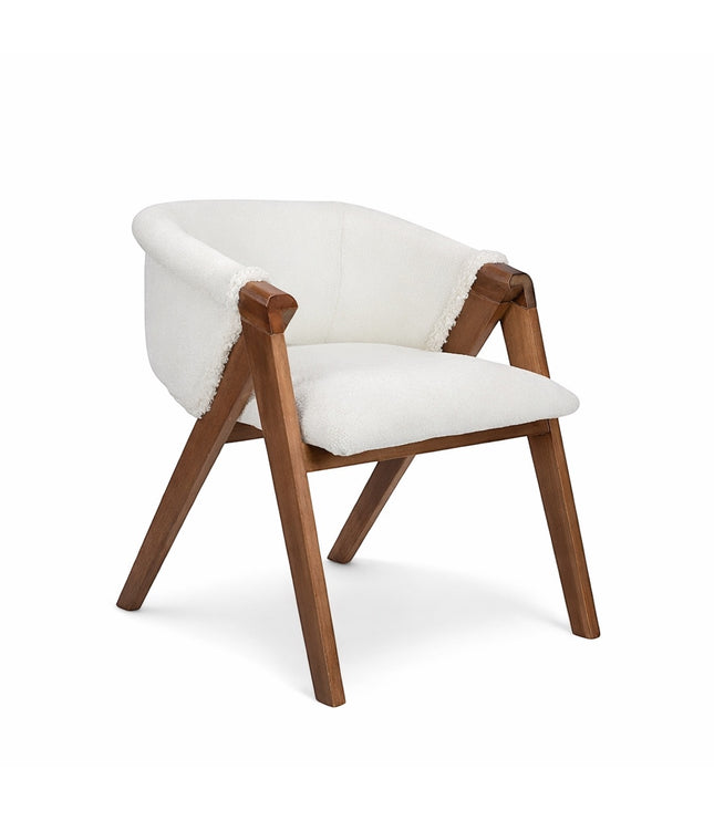 Front angled view of the Vaya Home Masiccio dining chair with white boucle upholstery, curved back, and wood frame.