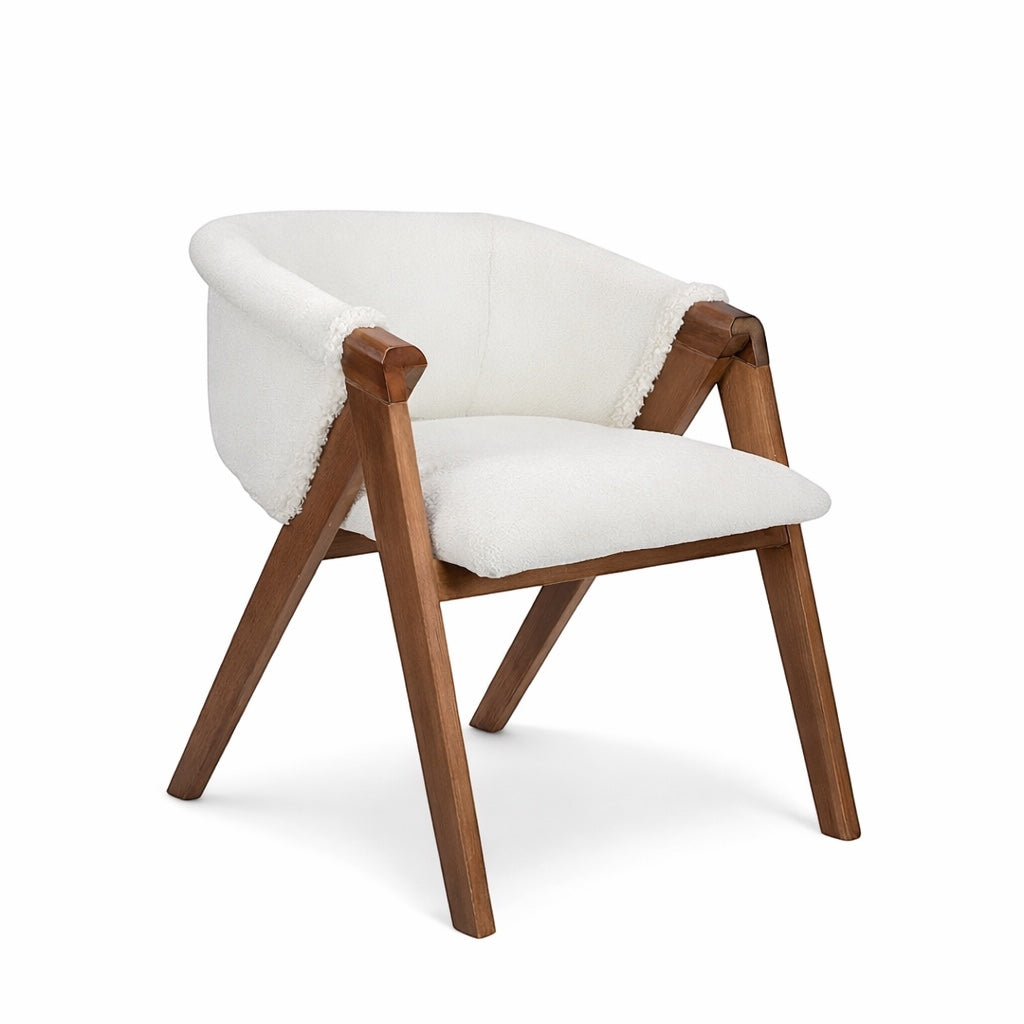 Front angled view of the Vaya Home Masiccio dining chair with white boucle upholstery, curved back, and wood frame.