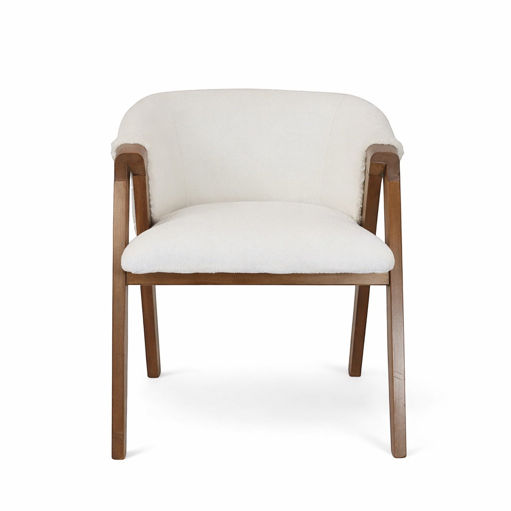 Front view of the Vaya Home Masiccio dining chair with white boucle upholstery, curved backrest, and wood arms.