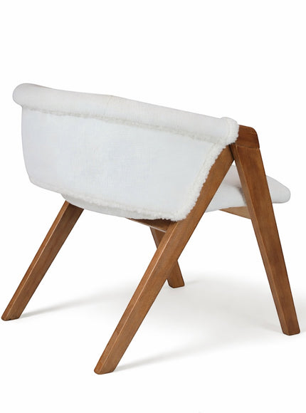 Rear angled view of the Vaya Home Masiccio dining chair with white boucle upholstery and a warm wood frame.