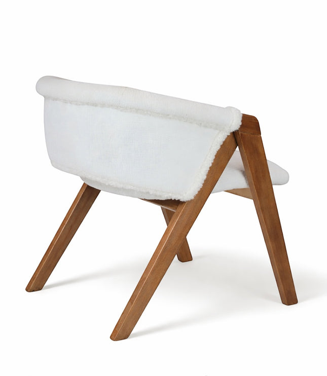 Rear angled view of the Vaya Home Masiccio dining chair with white boucle upholstery and a warm wood frame.