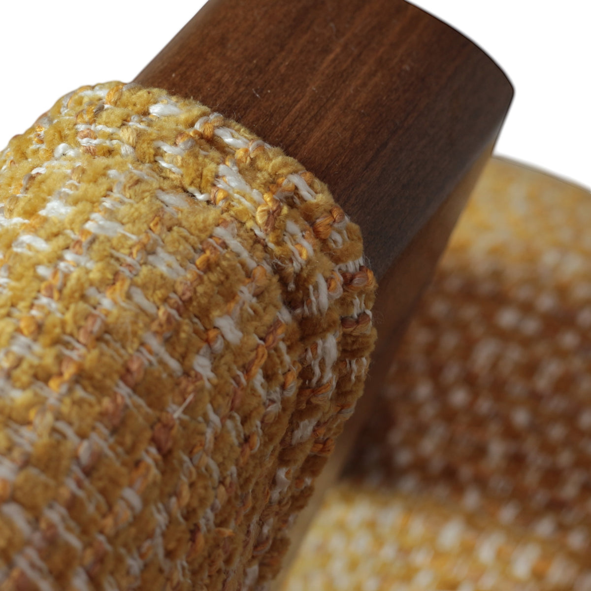 Close-up of the Vaya Home Masiccio dining chair showing yellow woven upholstery and wood frame detail.