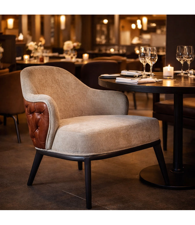 Vaya Home Mattonne accent chair with beige upholstery, a tufted burgundy outer back, and black legs, styled in an elegant dining setting.