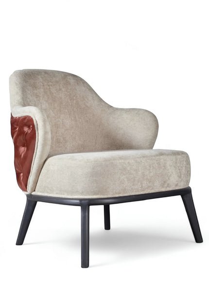Front angled view of the Vaya Home Mattonne accent chair with beige upholstery, curved silhouette, tufted burgundy side detail, and black legs.