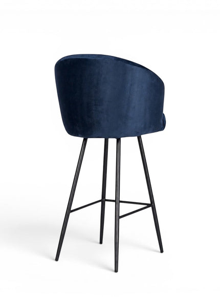 Back view of the Vaya Home Midnight bar stool with dark blue velvet upholstery and a black metal base.