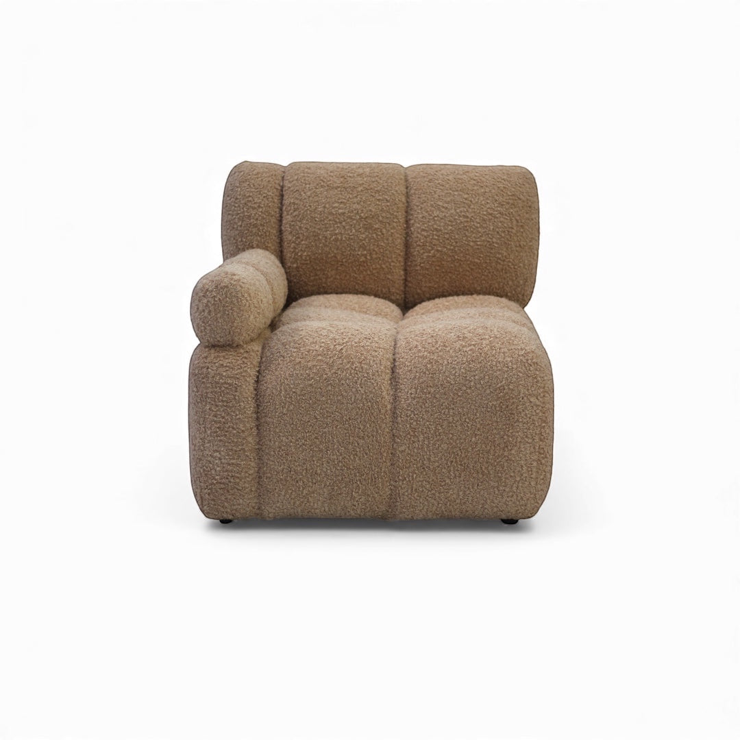 Front view of the Vaya Home Moducube corner module with beige boucle upholstery and one rounded armrest.