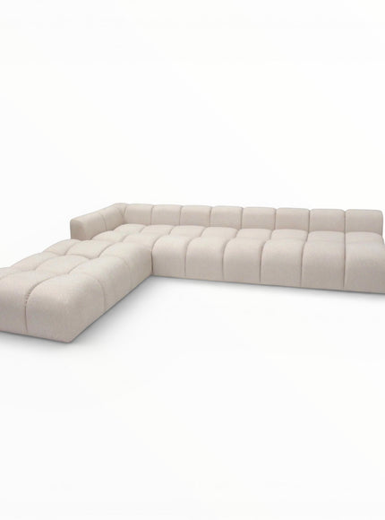 Opposite angled view of the Vaya Home Monolith modular corner sofa featuring cream upholstery and channel-tufted seat and back cushions.