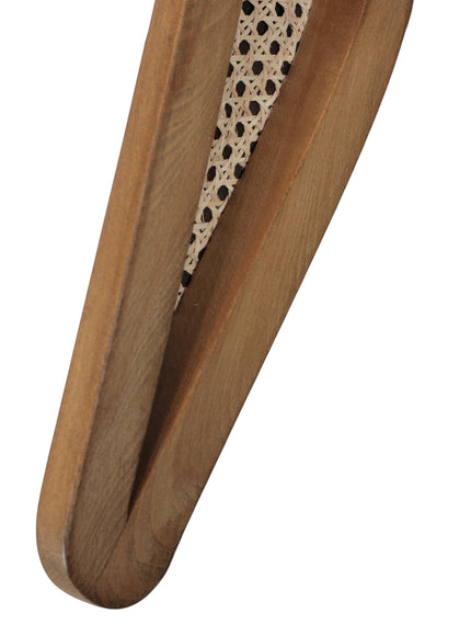 Close-up of the Vaya Home Morbido dining chair showing woven cane and curved wood frame detail.