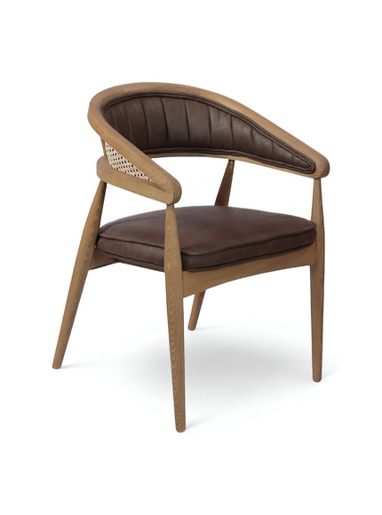 Vaya Home Morbido dining chair with a woven cane back, dark brown seat cushion, and curved wood frame.
