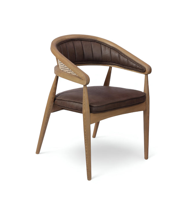 Vaya Home Morbido dining chair with a woven cane back, dark brown seat cushion, and curved wood frame.