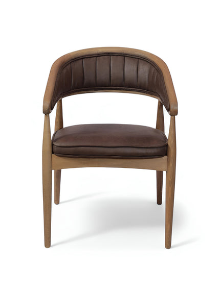 Front angled view of the Vaya Home Morbido dining chair with a woven cane back, dark brown seat cushion, and curved wood frame.