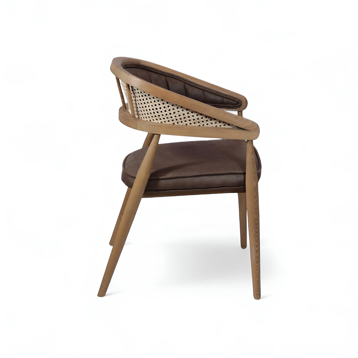 Rear angled view of the Vaya Home Morbido dining chair with a woven cane back, dark brown seat cushion, and curved wood frame.