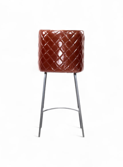 Back view of the Vaya Home Morkrod bar stool featuring dark brown quilted upholstery and black metal legs.