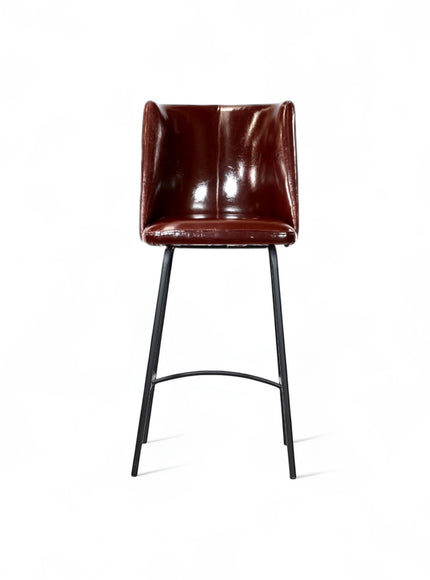 Front view of the Vaya Home Morkrod bar stool with dark brown quilted upholstery and black metal legs.