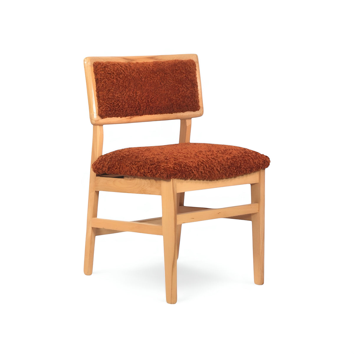 Front angled view of the Vaya Home Mouton dining chair featuring orange boucle upholstery and a natural wood frame.