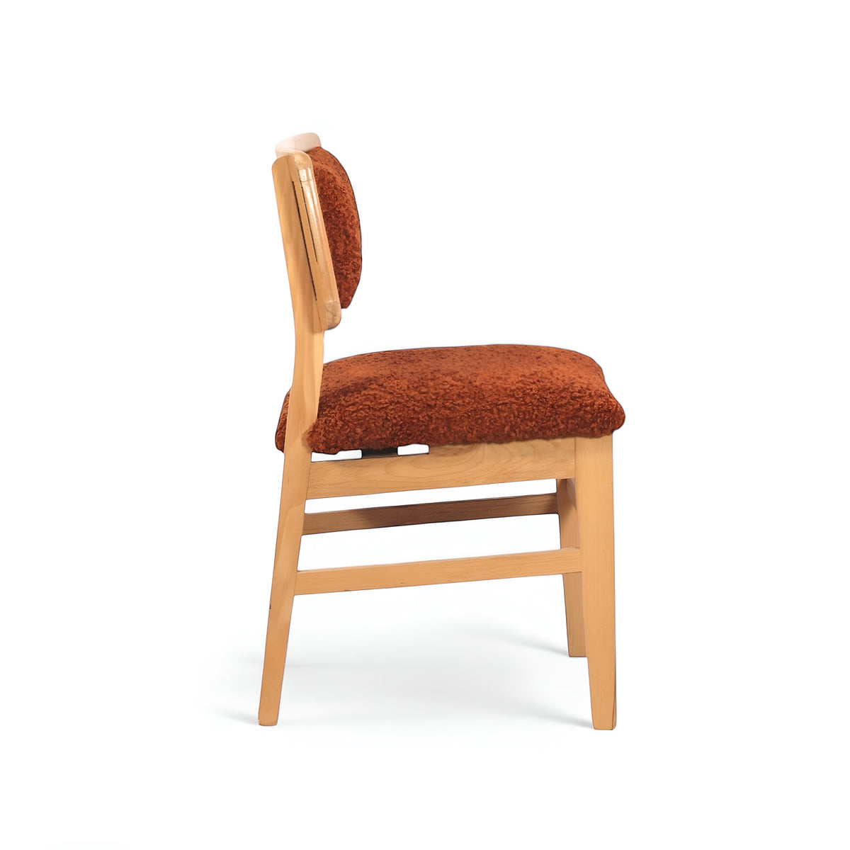 Opposite side view of the Vaya Home Mouton dining chair with orange boucle upholstery and a natural wood frame.