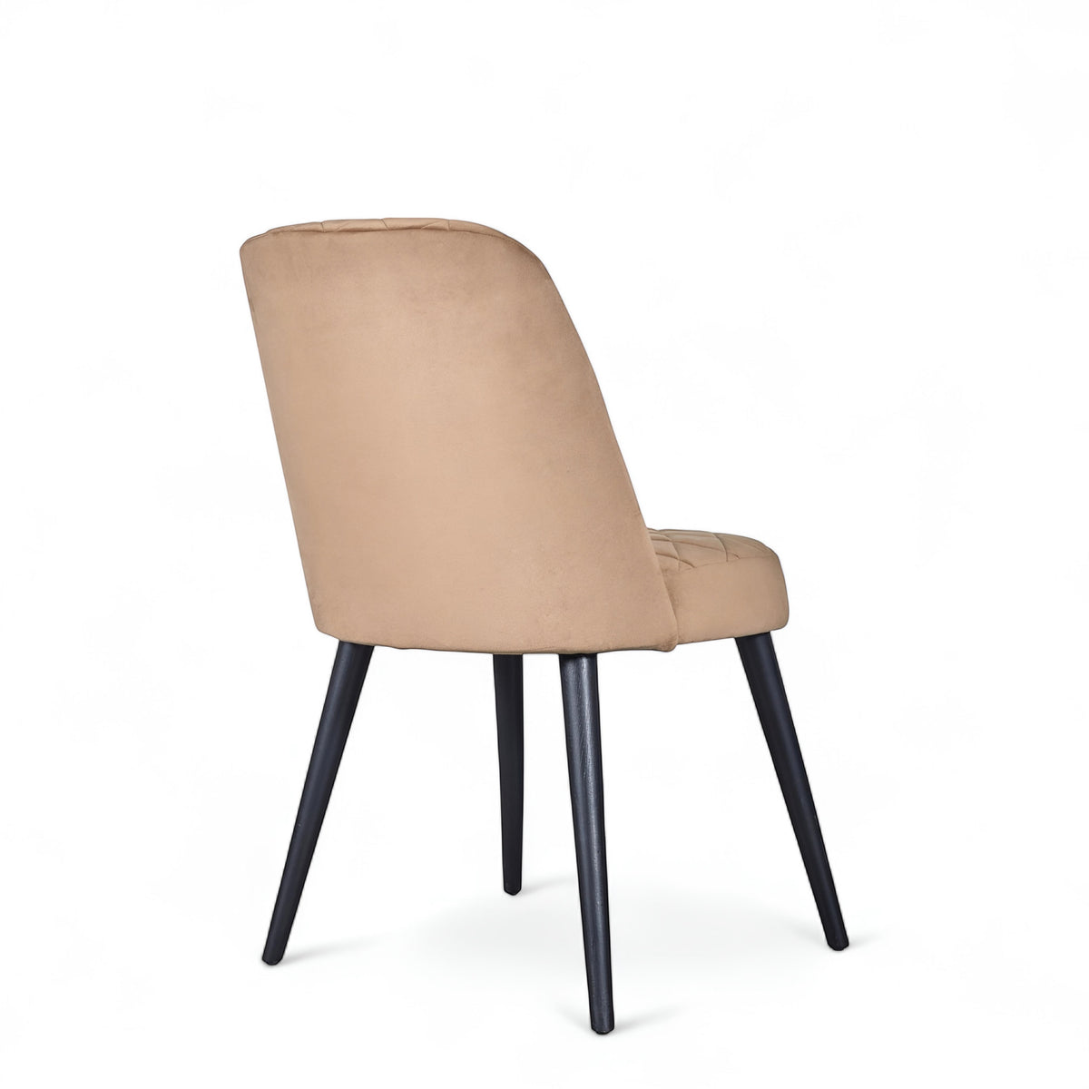 Rear angled view of the Vaya Home Netto dining chair featuring beige upholstery, a softly curved backrest, and black tapered legs.
