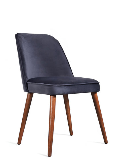 Front angled view of the Vaya Home Netto dining chair with dark blue upholstery, cushioned seat, and tapered wood legs.