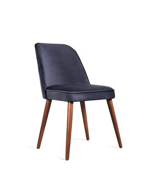 Front angled view of the Vaya Home Netto dining chair with dark blue upholstery, cushioned seat, and tapered wood legs.