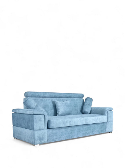 Angled view of the Vaya Home Opulence sofa with blue upholstery, plush back cushions, bolster pillows, and wide arms.