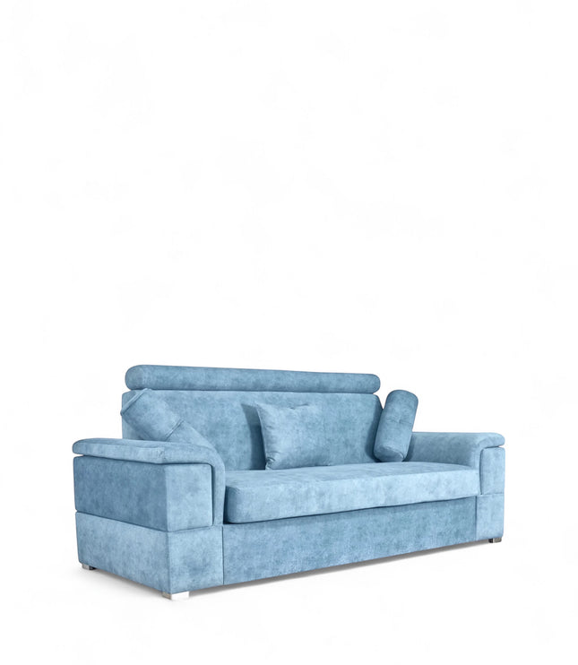 Angled view of the Vaya Home Opulence sofa with blue upholstery, plush back cushions, bolster pillows, and wide arms.