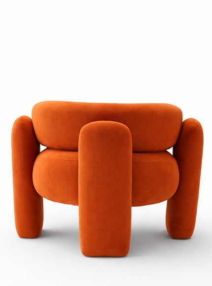 Back view of the Vaya Home Orbit accent chair showing its rounded backrest and sculptural orange upholstered frame.