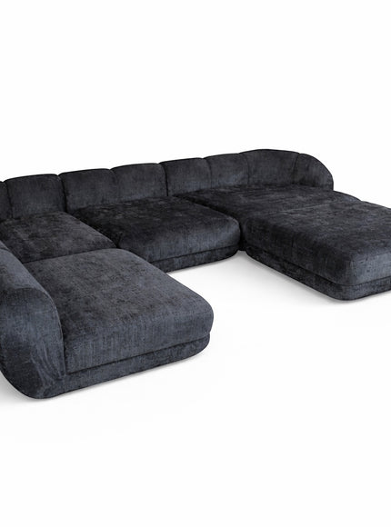 Angled view of the Vaya Home Origin modular sofa with charcoal textured upholstery and deep lounge seating.