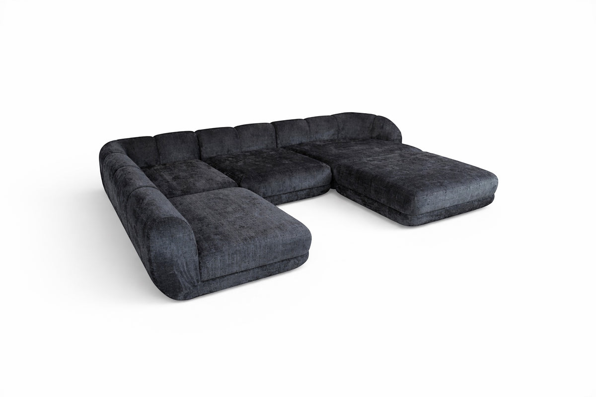 Angled view of the Vaya Home Origin modular sofa with charcoal textured upholstery and deep lounge seating.