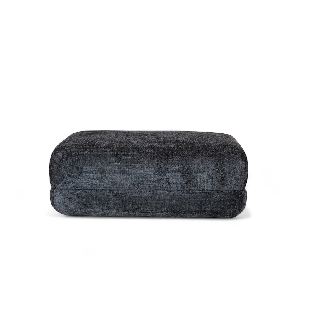 Vaya Home Origin ottoman in charcoal textured upholstery shown as an individual modular piece.