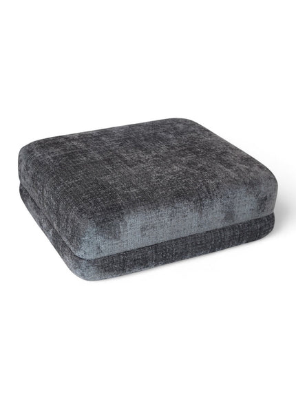 Angled view of the Vaya Home Origin ottoman in charcoal textured upholstery.