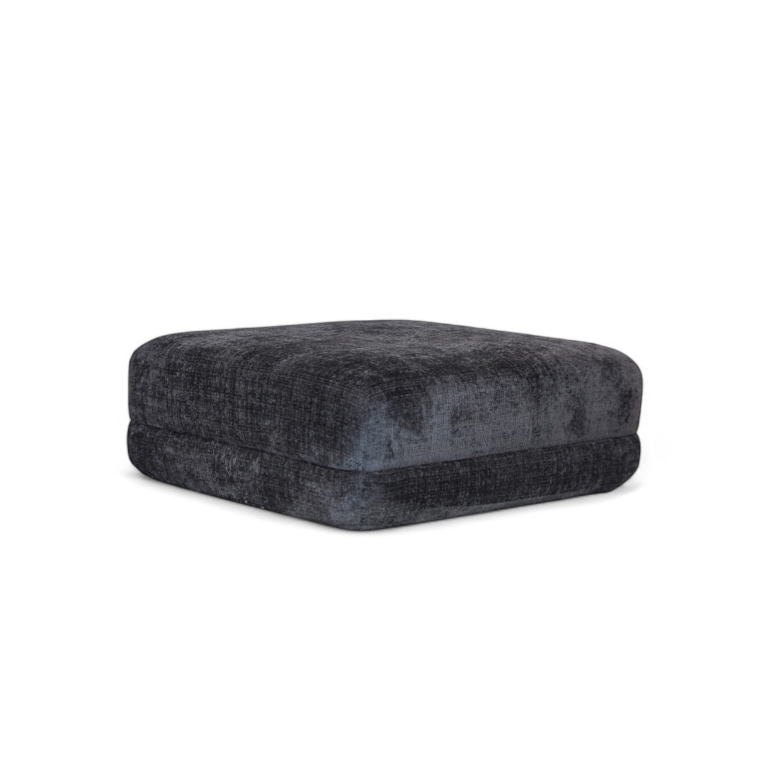 Vaya Home Origin ottoman in charcoal textured upholstery.