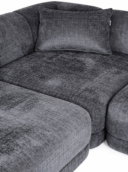 Close-up of the Vaya Home Origin modular sofa showing charcoal textured upholstery and plush cushion detail.