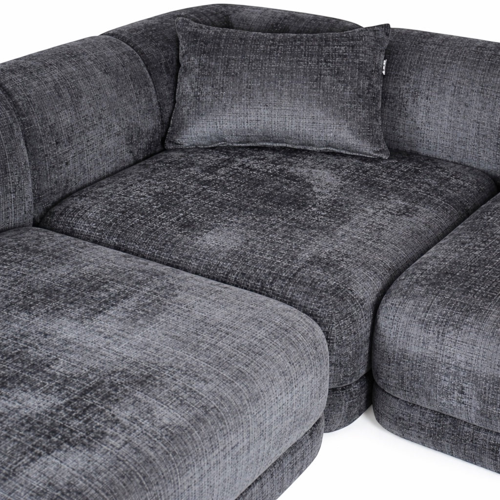 Close-up of the Vaya Home Origin modular sofa showing charcoal textured upholstery and plush cushion detail.