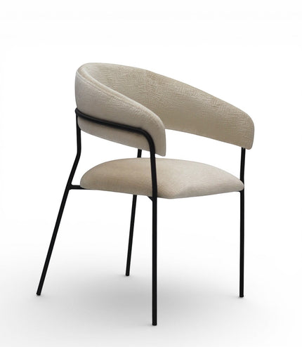 Vaya Home Osso dining chair with cream upholstery, curved wraparound backrest, and black metal frame.