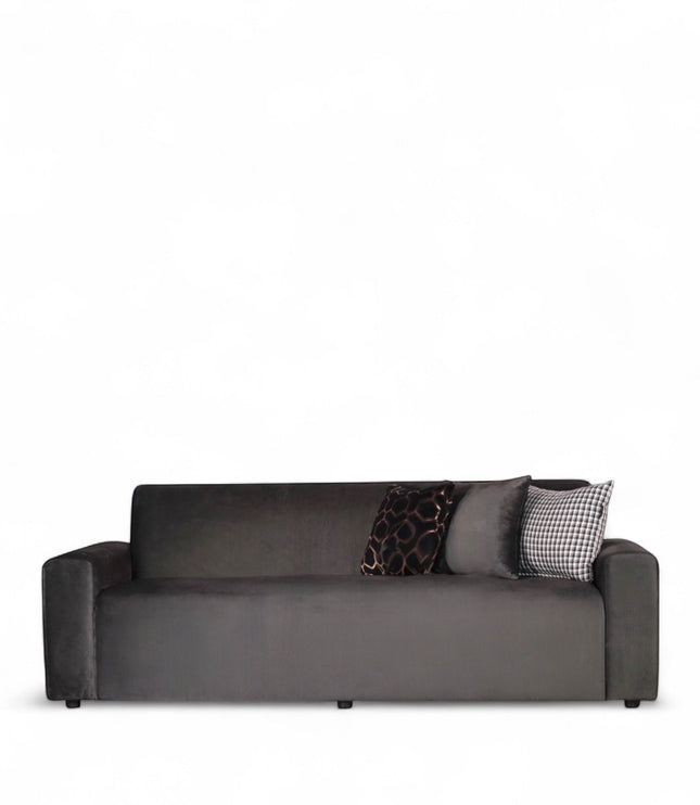 Front view of the Vaya Home Pacco sofa in grey upholstery with wide arms and accent cushions.