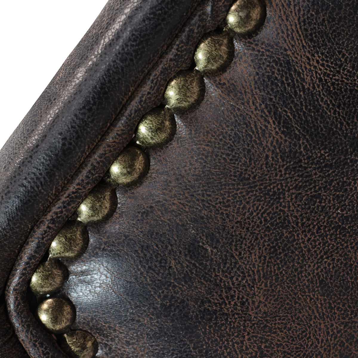 Close-up of the Vaya Home Pelle accent chair showing dark brown leather-look upholstery and nailhead trim detail.