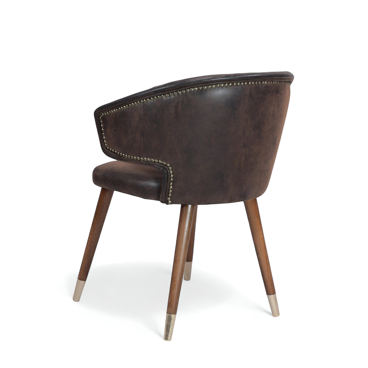 Rear angled view of the Vaya Home Pelle accent chair with dark brown leather-look upholstery, curved back, and tapered wood legs with metal caps.