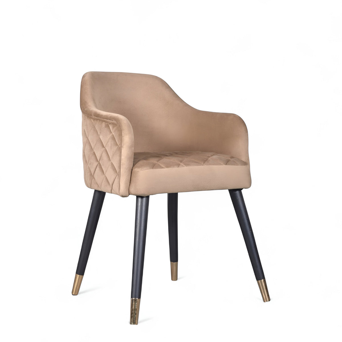 Front angled view of the Vaya Home Pino dining chair with beige upholstery, curved arms, and black tapered legs with gold caps.