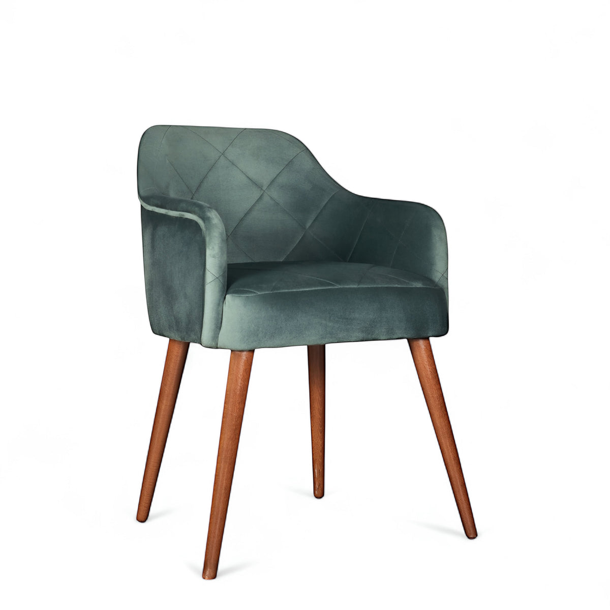 Front angled view of the Vaya Home Pino dining chair with green velvet upholstery, curved arms, and tapered wood legs.
