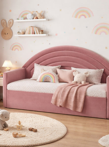 Vaya Home Rainbow kids bed in pink upholstery with an arched rainbow-style headboard, styled in a pastel children's bedroom.