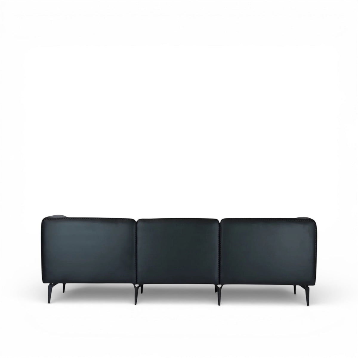 Back view of the Vaya Home Regalo sofa featuring black leather upholstery, three-panel backrest, and slim metal legs.