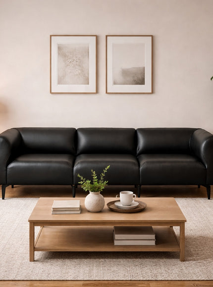 Vaya Home Regalo sofa in black leather, styled in a modern living room.